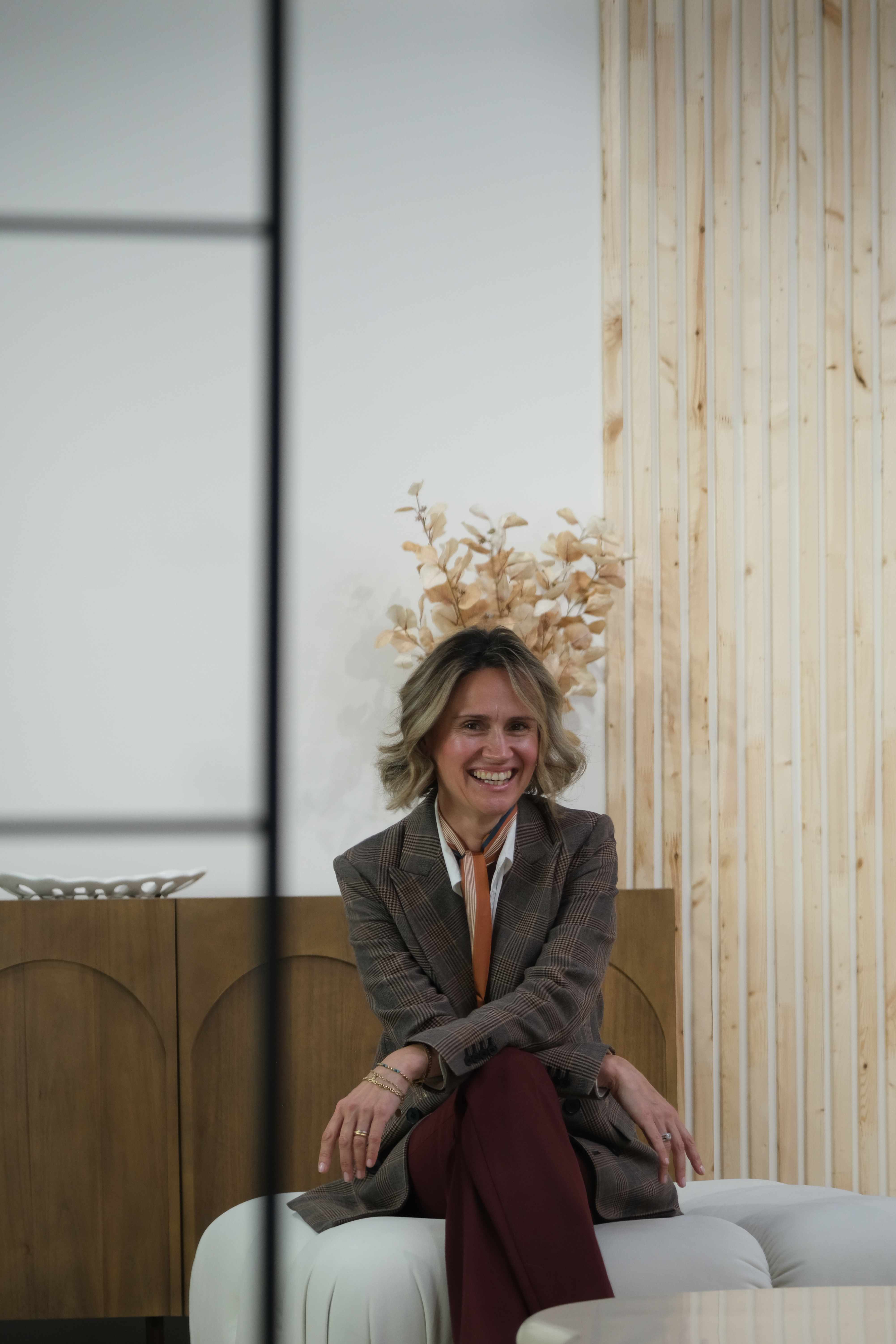 Nataliya Kolydchak sharing a warm laugh in a bright modern space